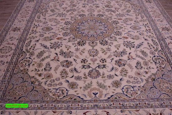 Handmade wool and silk rug made in India with Persian Nain pattern in beige and blue color