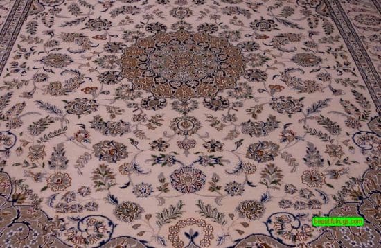 Handmade wool and silk rug made in India with Persian Nain pattern in beige and blue color