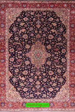 Hand knotted floral Persian Sarouk rug with navy blue filed and red border