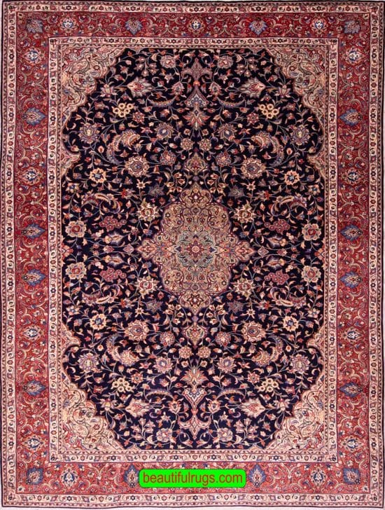 Hand knotted floral Persian Sarouk rug with navy blue filed and red border