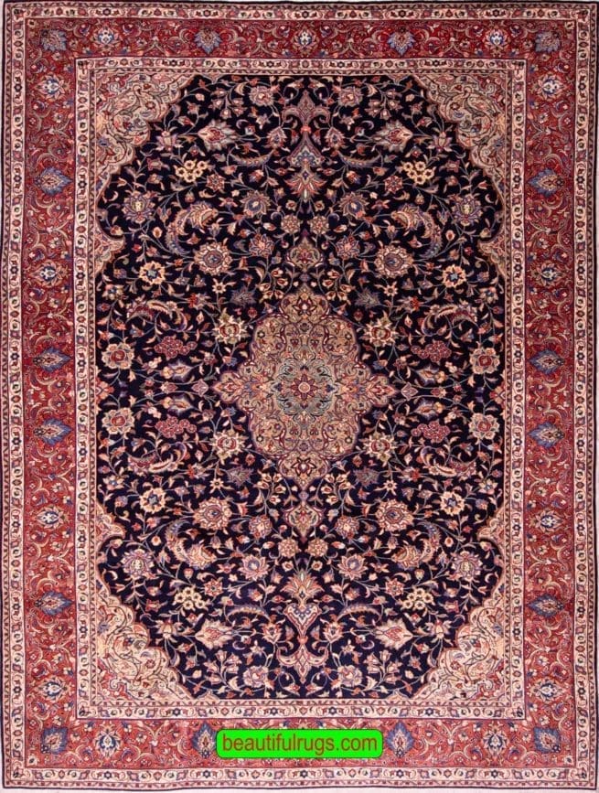 Hand knotted floral Persian Sarouk rug with navy blue filed and red border