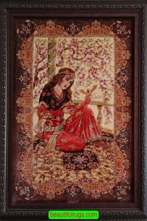 Handmade pure silk Persian Qum silk rug, woman is sitting on a rug with a bird in her hand. Size 2.7x4