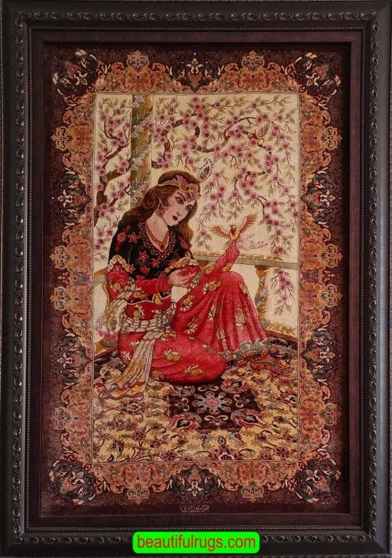 Handmade pure silk Persian Qum silk rug, woman is sitting on a rug with a bird in her hand. Size 2.7x4