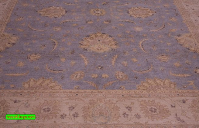 Vintage blue oriental rug with beige border, floral style. Size 8.1x10