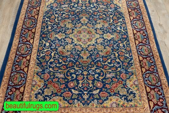 Persian Isfahan wool and silk rug with blue and gold colors. Size 4x6