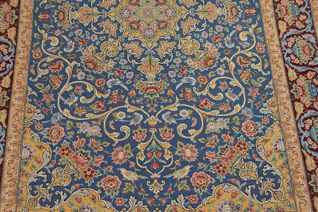 Persian Isfahan wool and silk rug with blue and gold colors. Size 4x6