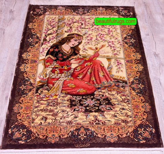 Handmade pure silk Persian Qum silk rug, woman is sitting on a rug with a bird in her hand. Size 2.7x4