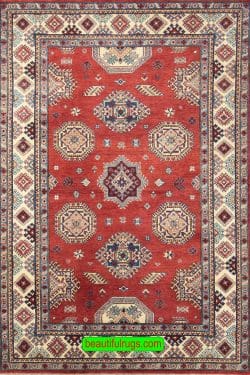 Handmade geometric Kazak style rug in red color. Size 6x9.4.