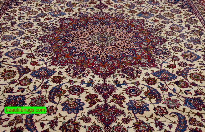 Antique Persian Isfahan rug with beige and red colors. Size 10.2x15.7.
