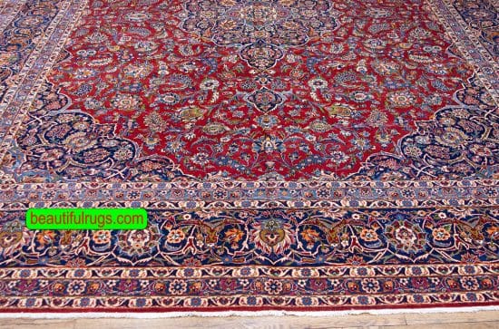 Semi antique Persian Kashan rug with orange red and navy blue color. Size 11.3x14.7.