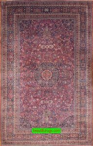 Antique Persian Mashad rug with red and navy blue. Size 12x18.9.