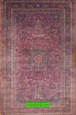 Antique Persian Mashad rug with red and navy blue. Size 12x18.9.