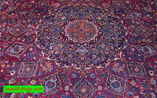 Antique Persian Mashad rug with red and navy blue. Size 12x18.9.