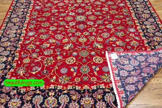 Handmade wool Persian Kashan area rug in red color and allover design. Size 6.6x9.7.