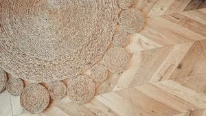 A round shape braided rug on a light color hardwood floor