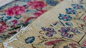 Image of a Persian Kerman rug with damaged edges
