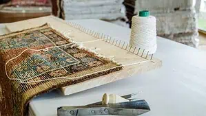 Image of a rug being prepared for weaving new fringes