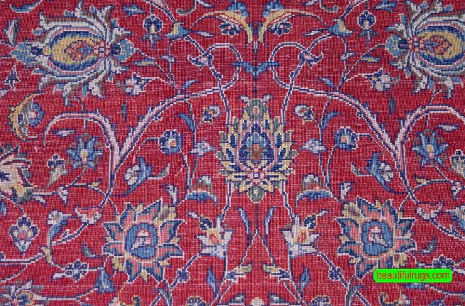 Hand knotted Persian Sarouk area rug with red and navy blue made of wool. Size 7.1x10.4.
