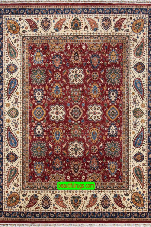 Handmade wool rug with floral and geometric motifs with red color in the center and beige border. Size 8.3x10.4.