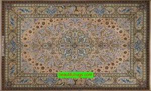 A handmade Persian Isfahan silk rug with blue, brown, gold, earth tone colors.