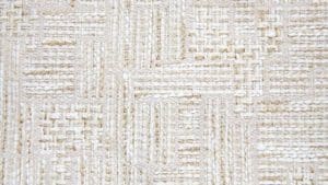 Small sample of a flat weave rug with squares in white and beige colors.