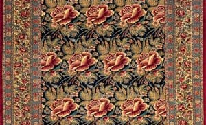 Partial image of a wool floral Persian rug with red flowers.