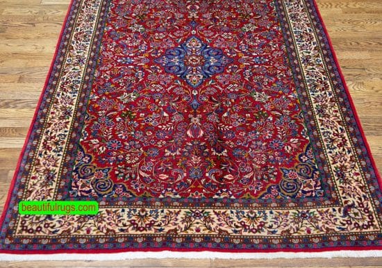 Handmade floral Persian Sarouk wool rug in red and beige colors. Size 4.3x6.9.