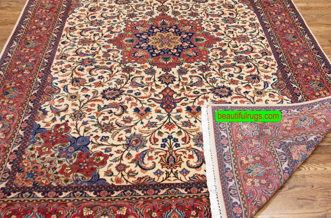 Handmade floral Persian Sarouk wool area rug with beige and red colors. Size 6.9x10.