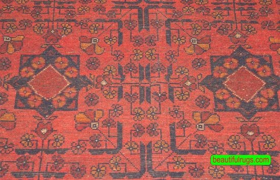 Handmade Afghan Kunduz rug in red and black color made of wool. Size is 4.10x6.7.