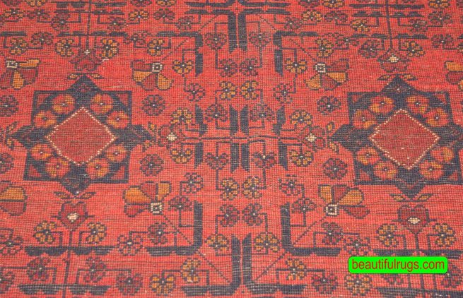 Handmade Afghan Kunduz rug in red and black color made of wool. Size is 4.10x6.7.