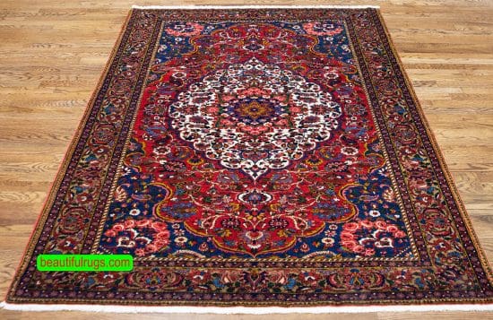 Handmade antique Persian Bakhtiari wool rug in red color. Size 5x7.8.