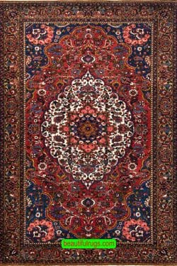 Handmade antique Persian Bakhtiari wool rug in red color. Size 5x7.8.