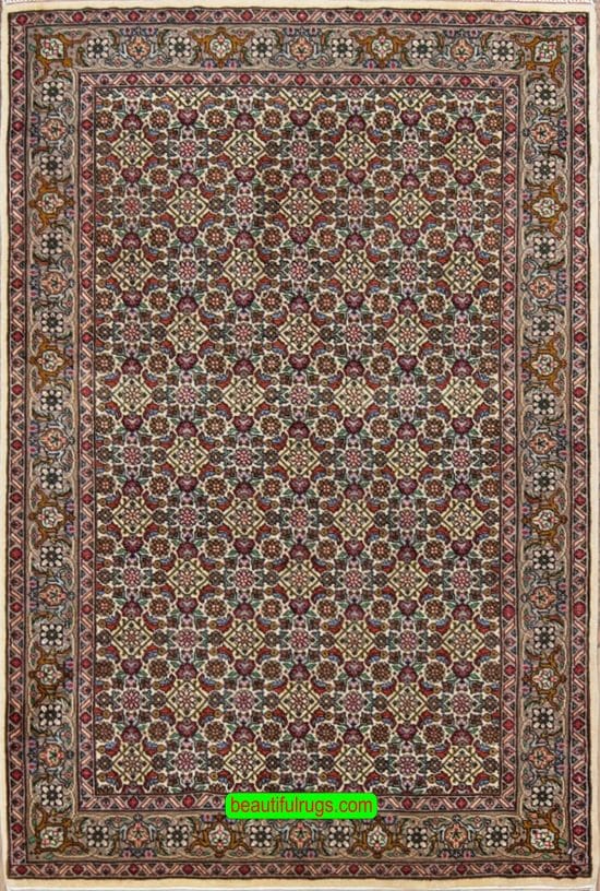 Handmade Persian area rug made of wool, multi color with pastel beige color in the main field and all-over design. Size 3.3x5.