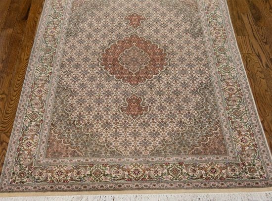 A classic design wool and silk handmade Persian carpet in beige and green colors. Size 3.5x5.3.