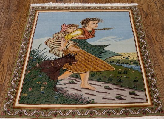 Handmade Persian Tabriz pictorial rug showing a mother is carrying her daughter on her back and a goat is following them. Rug size 2x3.9.