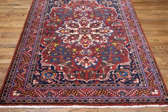 Vintage Persian Bakhtiari wool rug with terracotta and blue colors. Rug size 4.8x6.8.