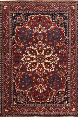 Vintage Persian Bakhtiari wool rug with terracotta and blue colors. Rug size 4.8x6.8.