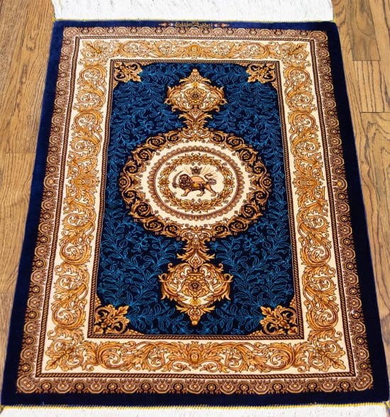 Hand knotted Persian Qum pure silk rug in royal blue and gold colors with lion and sun symbol.