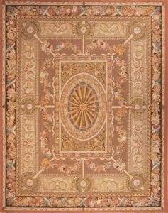 A flat weave petit point wool rug with French Aubusson design in pastel and light brown colors. Rug size 7.10x10