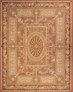 A flat weave petit point wool rug with French Aubusson design in pastel and light brown colors. Rug size 7.10x10