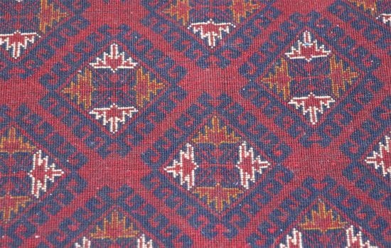 Hand knotted tribal Afghan Turkmen rug in red and navy-blue colors. Rug size 4.10x6.7.