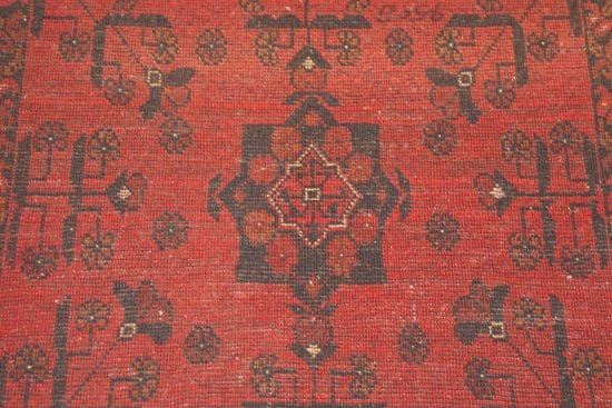 Handmade tribal area rug from Afghanistan with red and black colors. Rug size 3.6x5.1.