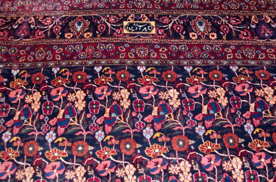 Old Persian Birjand Dorokhsh rug. Floral allover design Persian rug, multi color with navy blue background. Size 10x13.4.