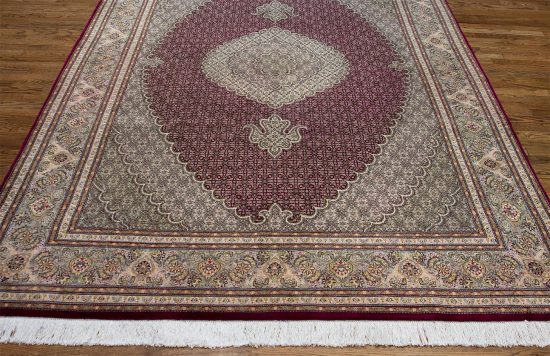 A classic style Persian Tabriz wool and silk rug in red color. Size 6.7x10.