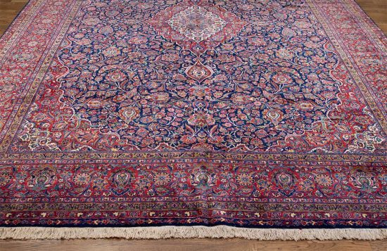 Real Persian rugs. A magnificent vintage floral Persian Kashan rug in navy blue and red border. Size 10.4x14.