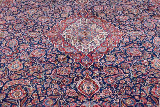 Real Persian rugs. A magnificent vintage floral Persian Kashan rug in navy blue and red border. Size 10.4x14.