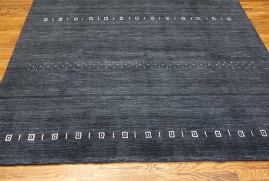 Charcoal gray area rug made of 100 percent wool in Gabbeh style made in India. Size 6.2x9.1.