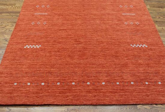 Modern rust area rug crafted in India made of 100% wool. Size 5.4x8.1.