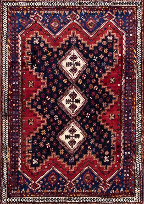 2646- This 5x8 geometric area rug from Sirjan, Iran is handmade from fine wool on a cotton foundation. Its bold navy blue and red geometric design reflects the artistry of traditional Persian weaving, available at Beautiful Rugs Chicago.