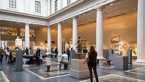 Image of Metropolitan Museum of Art in New York. Visitors are admiring statues. Image of Metropolitan Museum of Art in New York. Visitors are admiring statues.
